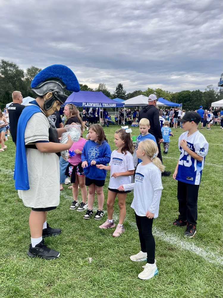 picture of group of younger students with the Trojan mascot