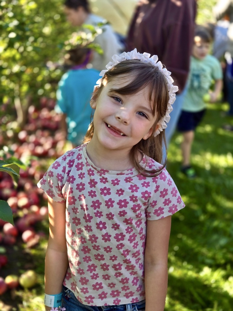 picture of a young 5 student at the apple orchard