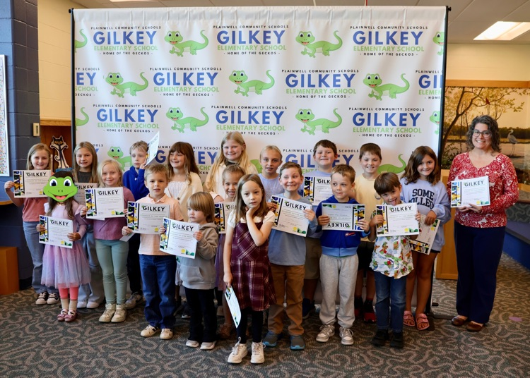 group picture of Gilkey’s September student and staff of the month. pictured in front of their Gilkey backdrop.