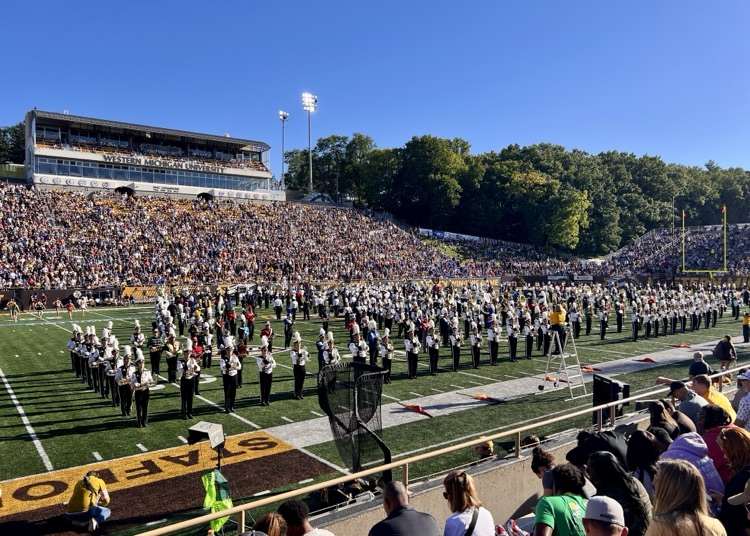 picture of phs marching band students performing with western Michigan university’s marching band at Waldo stadium