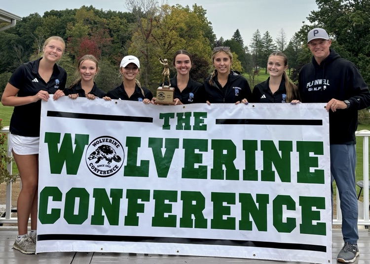 picture of the varsity girls golf team holding a trophy and banner with the Wolverine conference written