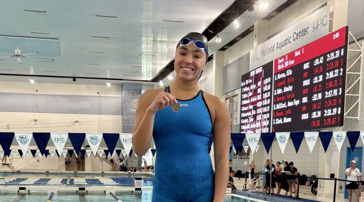 picture of phs girls swimmer holding a medal