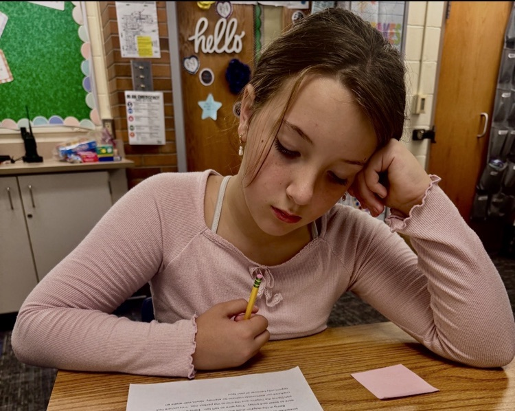 picture of a student reading a written story from a classmate