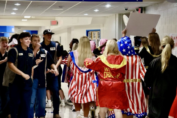 picture of groups of students dressed up for homecoming week in the hallways at phs