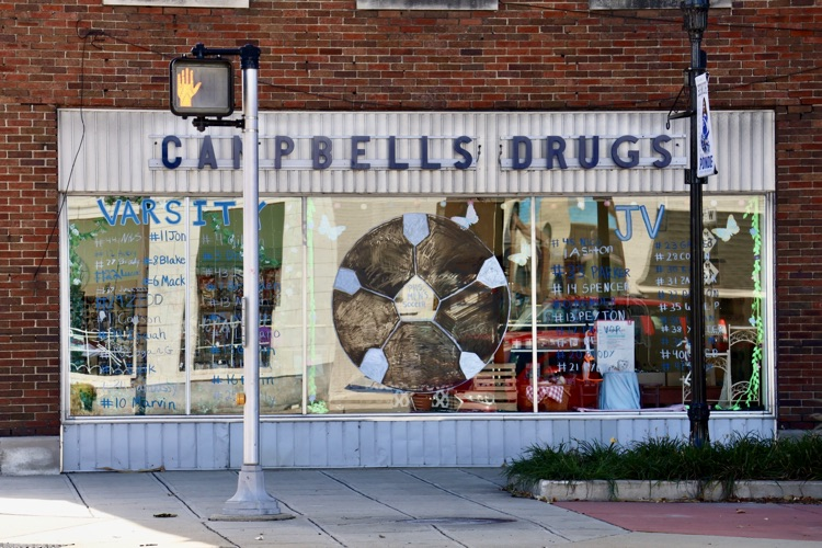 picture of downtown business with windows painted for homecoming week