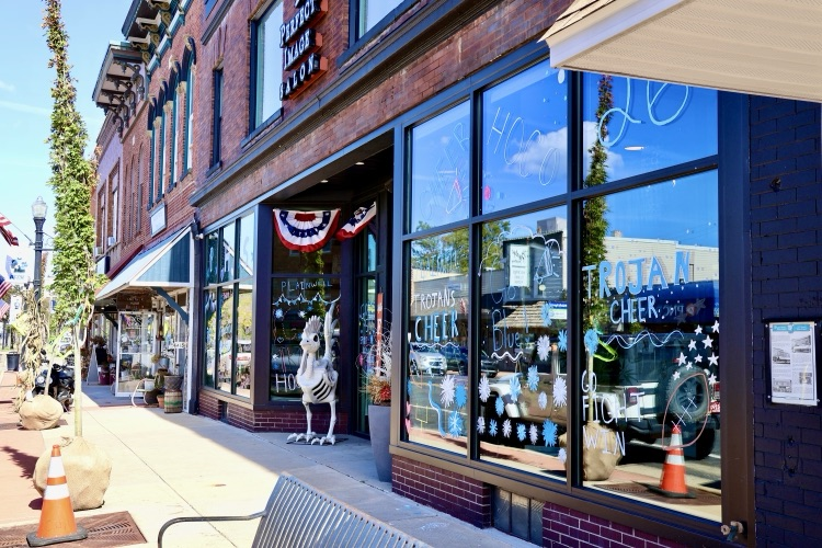 picture of downtown business with windows painted for homecoming week