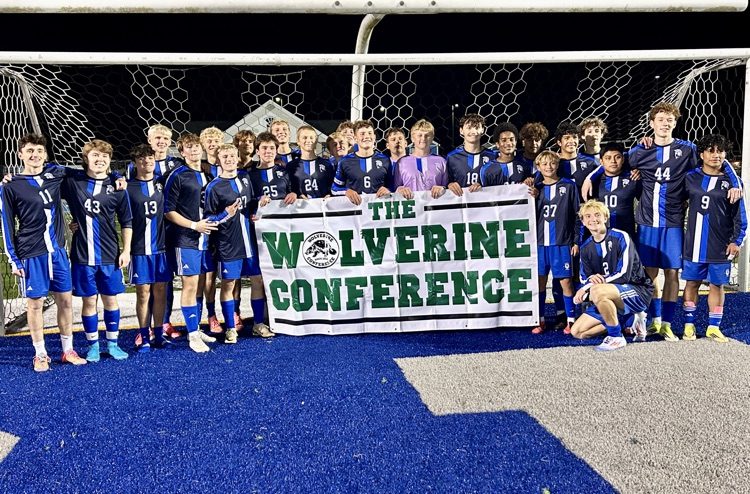 picture of varsity soccer team with Wolverine conference banner