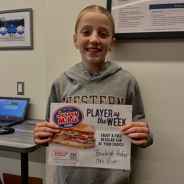 picture of middle school student holding a player of the week certificate