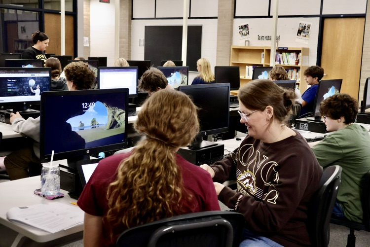 picture of a phs counselor working with a student on their college application process