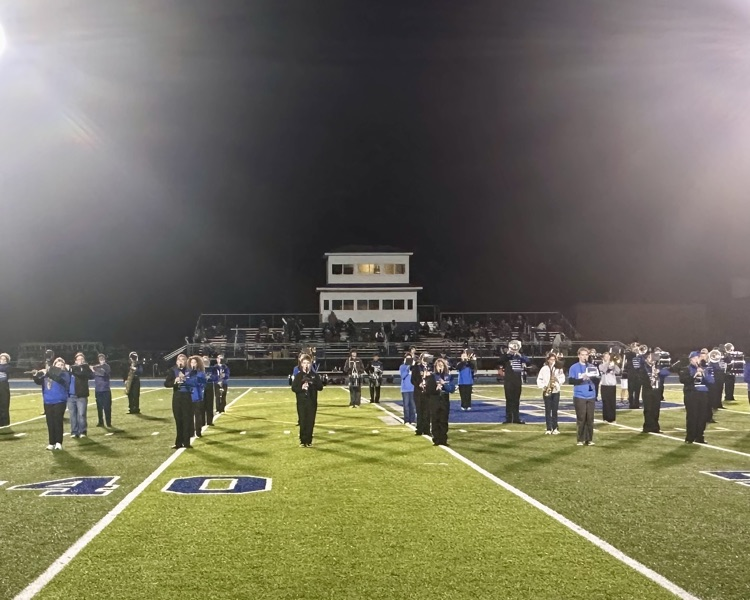 picture of marching band students with 8th graders performing at Streidl field