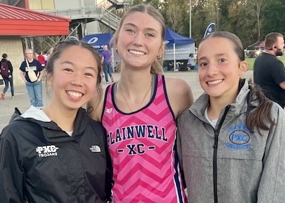 picture of three Trojan varsity cross country girls runners
