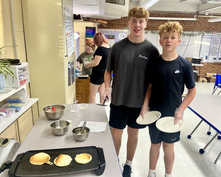 picture of two students in food and nutrition class making pancakes