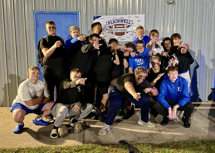 picture of jv football team gathered for a picture after a big win