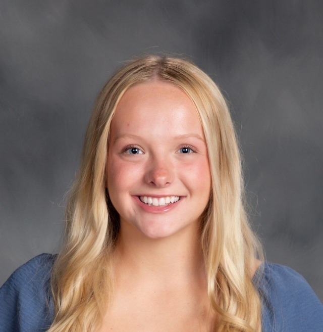 blonde female student with a blue shirt