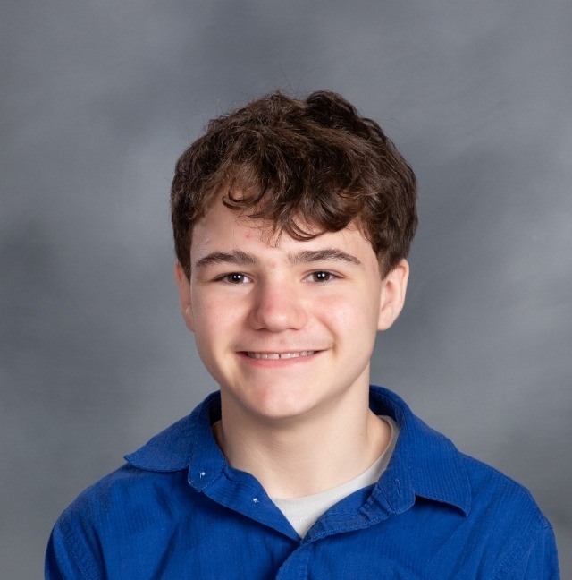 male student with brown hair and a blue buttoned down shirt