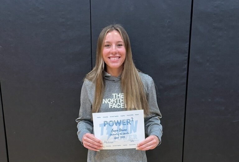 FEMALE STUDENT WITH long brown hair, a grey north face hoodie