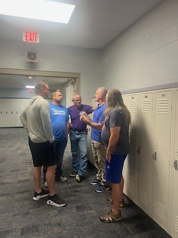 several staff members talking with our presenter during an activity
