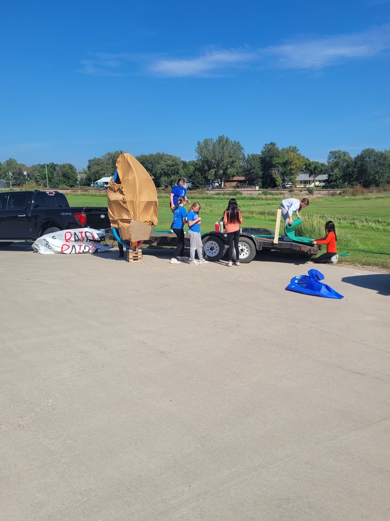 7th graders putting the final touches on their big football for their float