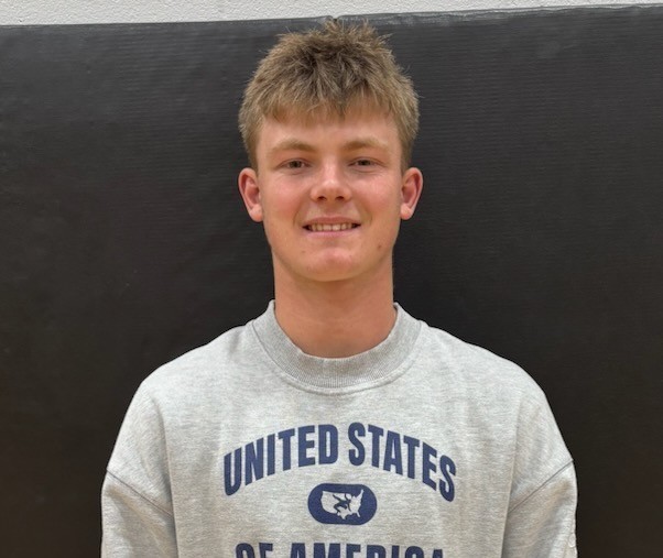 male student with light brown hair and a grey sweatshirt