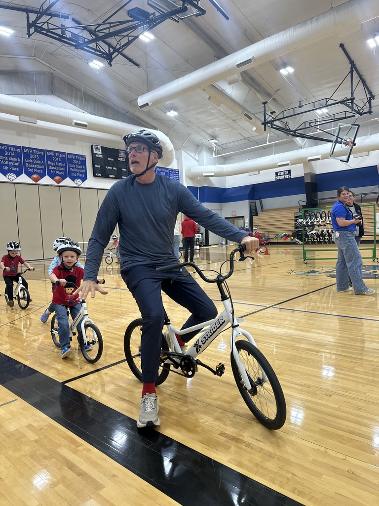 male teacher riding the trainer bike for the KDG bike program