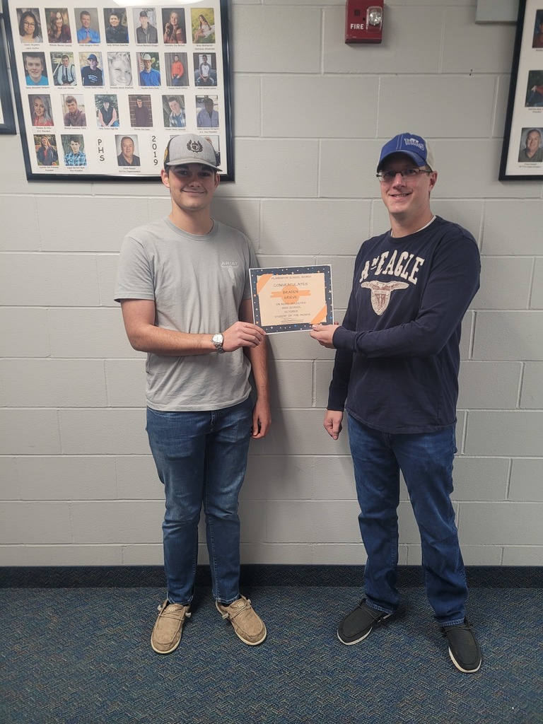 male student being recognized as Student of the Month at the school board meeting