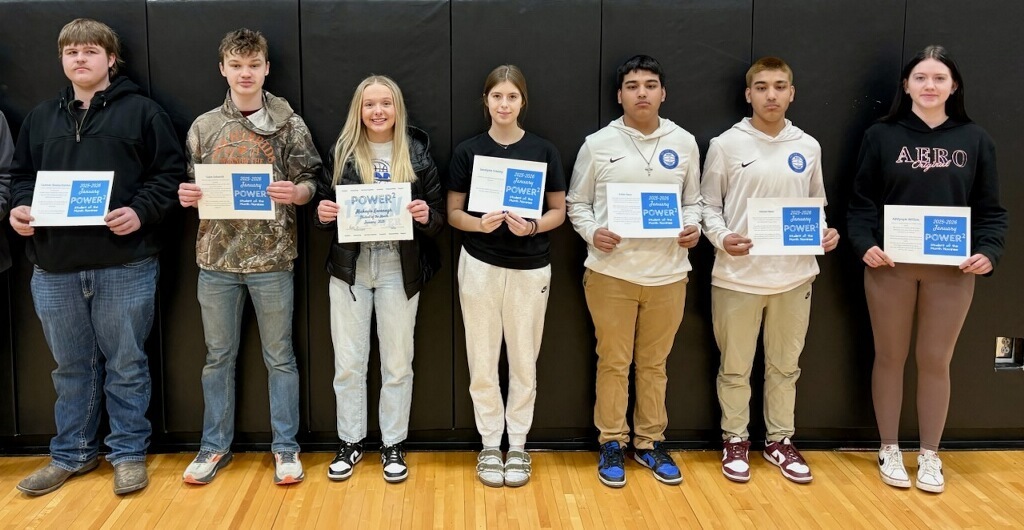 seven students that were nominated for student of the month all wearing different types of clothes