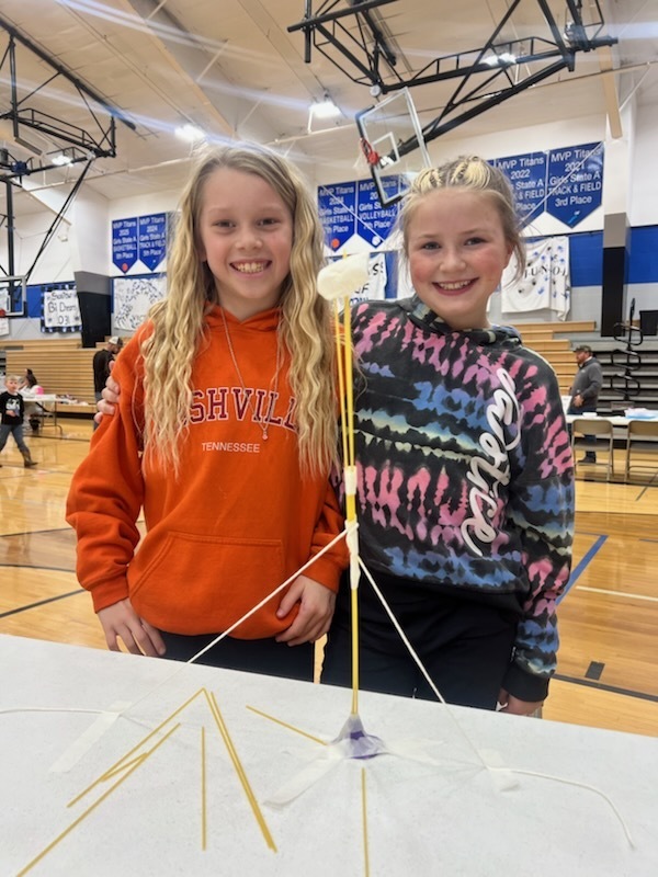 two students creating a marshmallow tower at family fun night