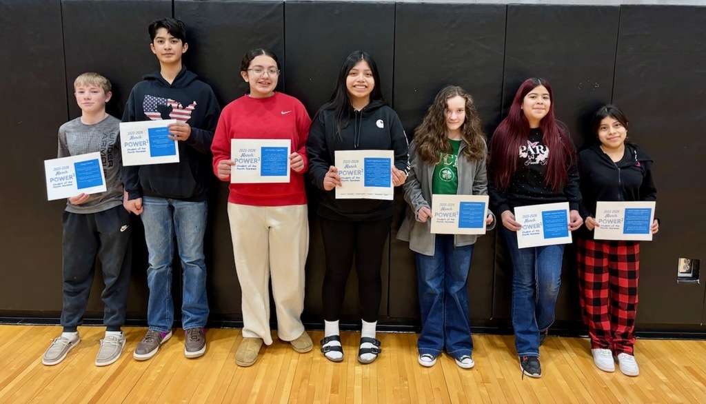 seven students that were nominated for student of the month all wearing different types of clothes