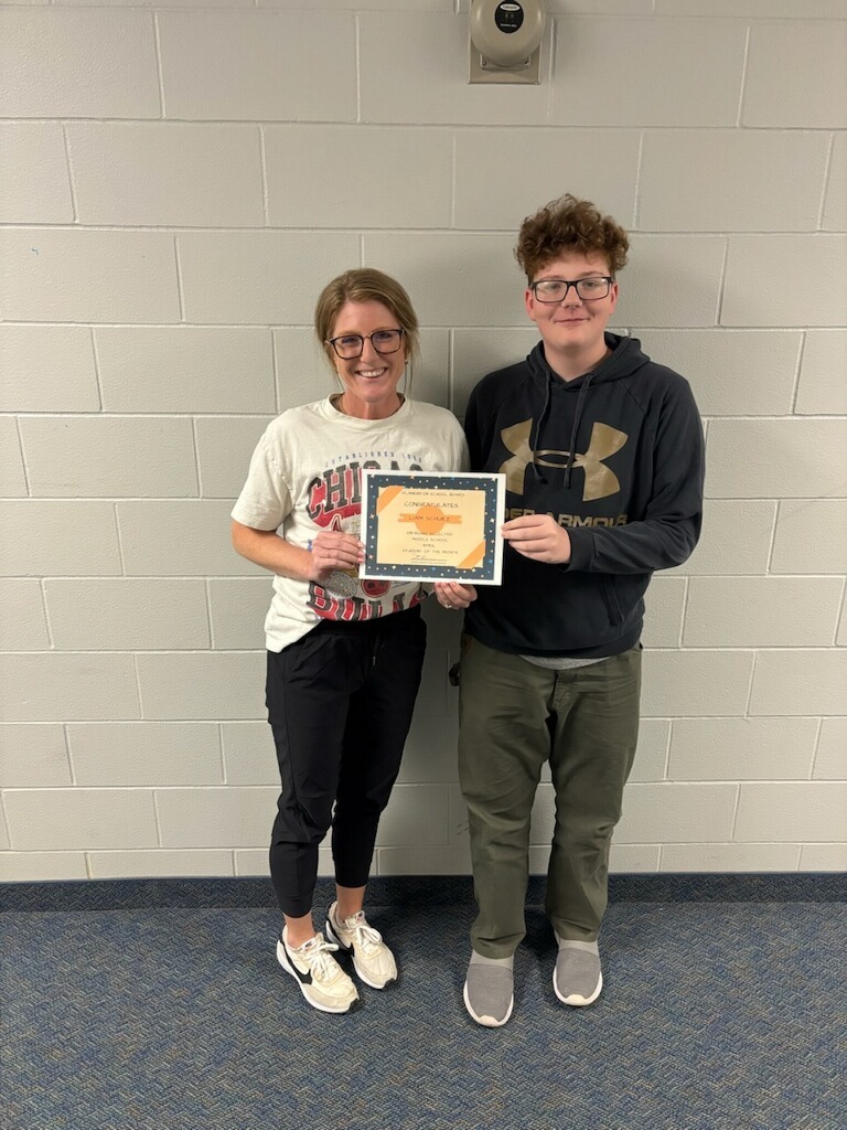 school board member congratulating middle school student of the month for April