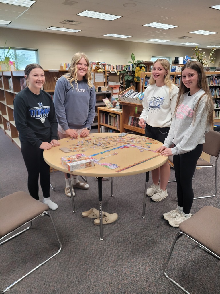 students putting together puzzles in the library