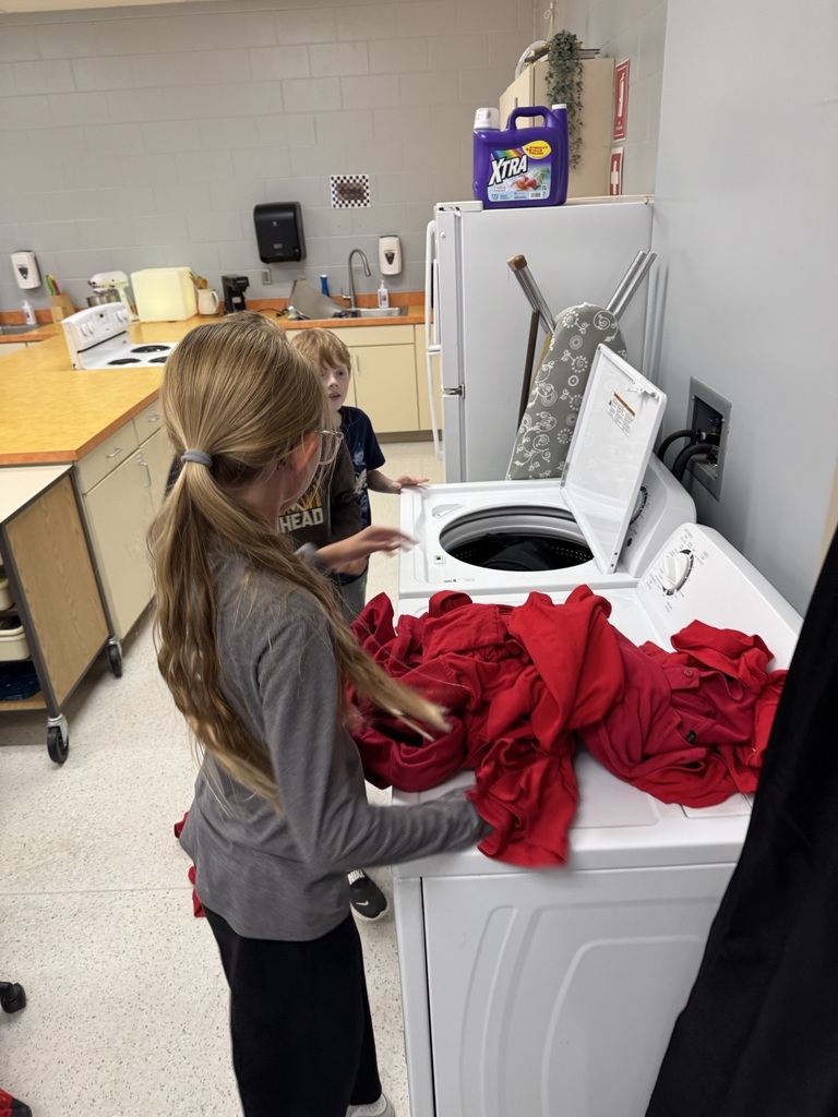 Filling the washer with clothes to watch.