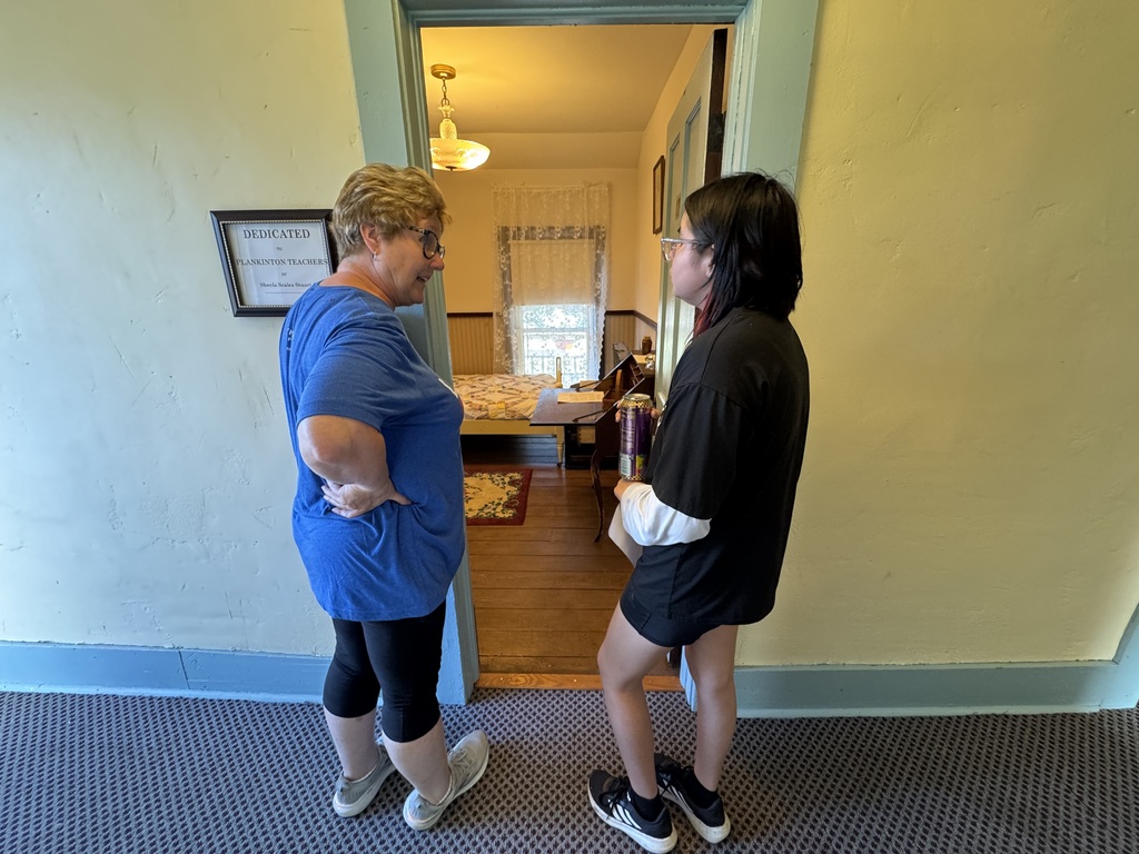 Kathy Guindon talking to a student about the design choices of the rooms.