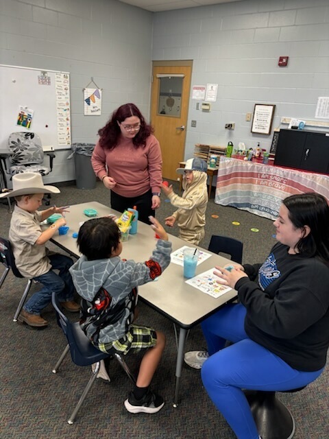 older students working with younger students for a homecoming activity