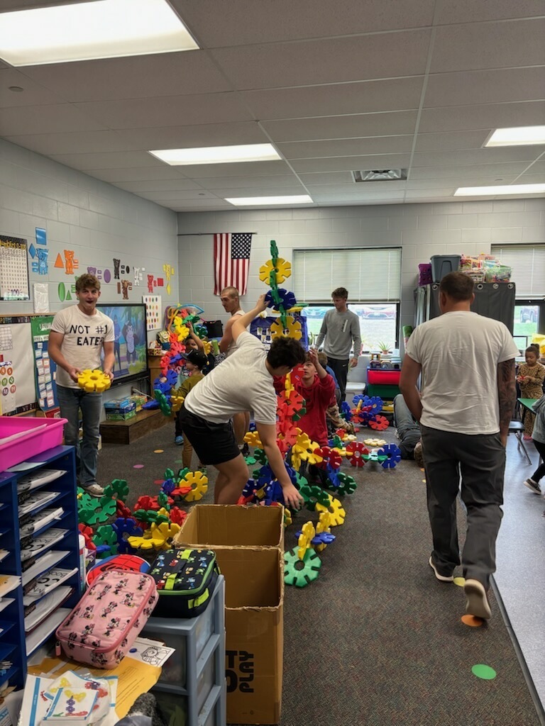 older students working with younger students for a homecoming activity