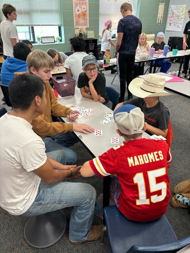 younger students working with older students for a homecoming activity
