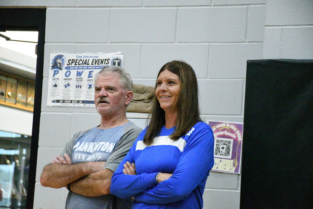Mrs. Victor and Mr. Bathke exchange laughs as they watch senior games. 