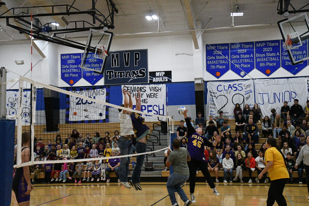 Mrs. Overweg goes up against Walker VanGorp and Ethan Hoffman in volleyball students vs staff.