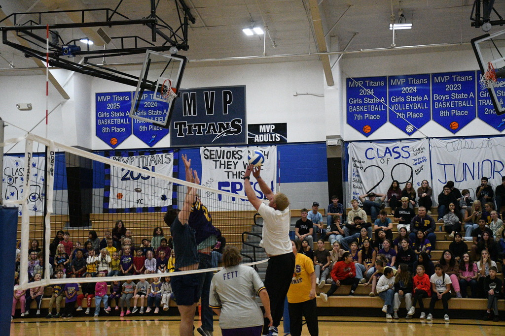 Mr. Bruinsma push tips the volleyball against blockers Ethan Hoffman.