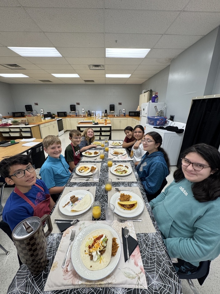 Students sitting down to enjoy their meals.