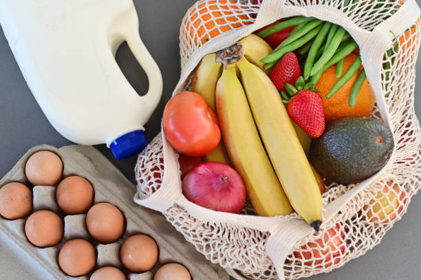 bag of fruits and veggies, eggs and milk