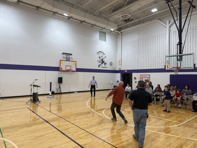 Board member Campbell tossing the ball for The Impossible Shot