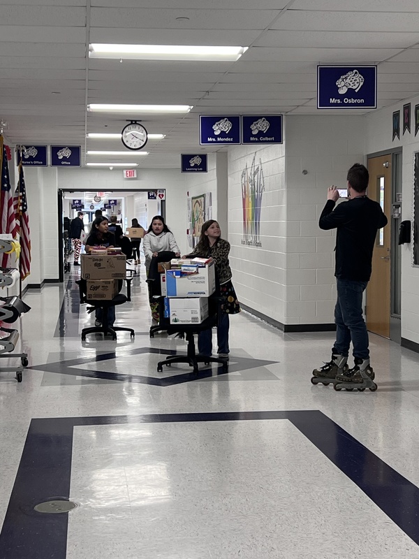Students pushing carts with food