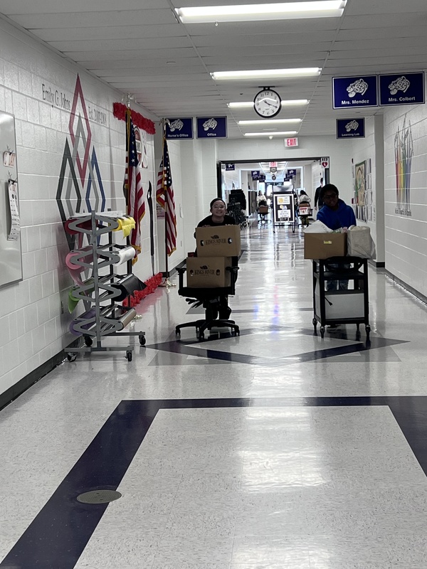 Students pushing carts with food