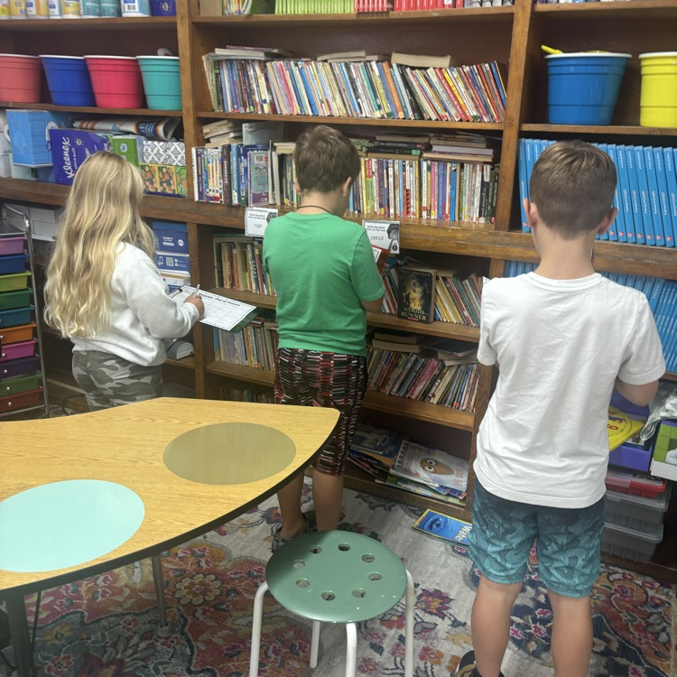 Mrs. Colliers third-grade class is practicing turning singular nouns into plurals with task cards. 