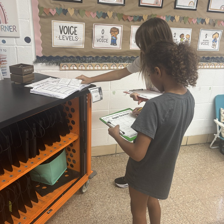 Mrs. Colliers third-grade class is practicing turning singular nouns into plurals with task cards. 