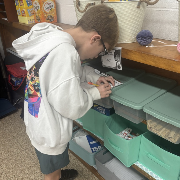 Mrs. Colliers third-grade class is practicing turning singular nouns into plurals with task cards. 