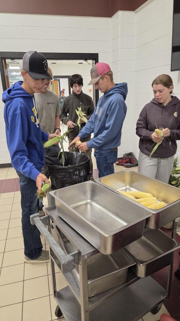 Senior Ag students shucking corn