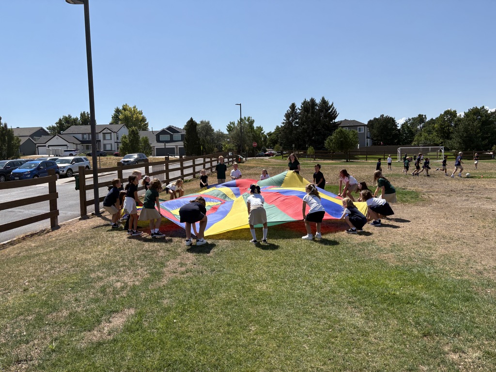 Children playing with large parachute