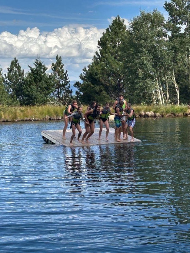 Kids diving off floating dock into water