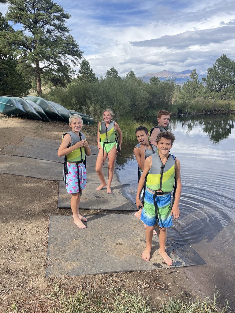 5 boys getting ready to jum in the lake